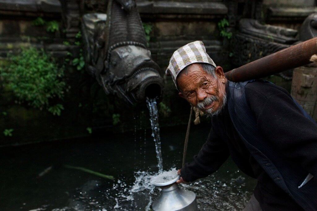 newar man in kathmandu nepal watering Most Beautiful City in Nepal